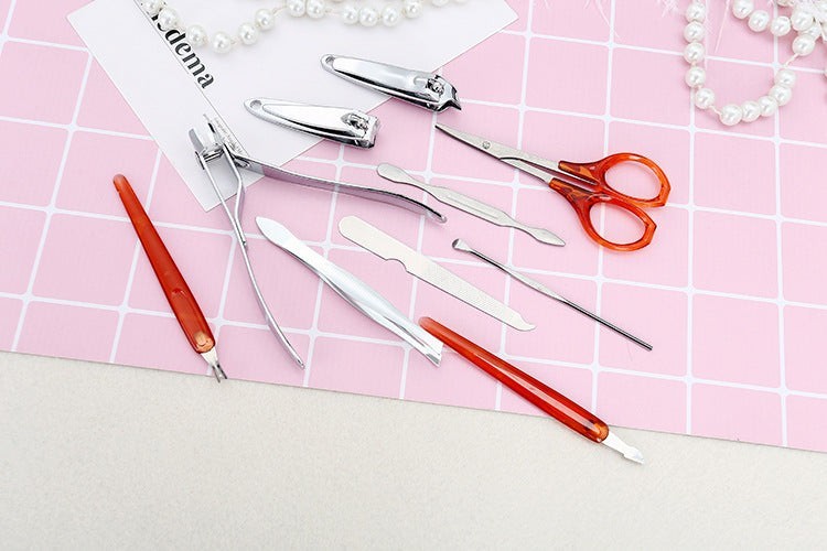 TheGromify Professional Manicure and Pedicure Tool Set includes clippers, scissors, files, and cuticle tools. Silver metal with orange handles.