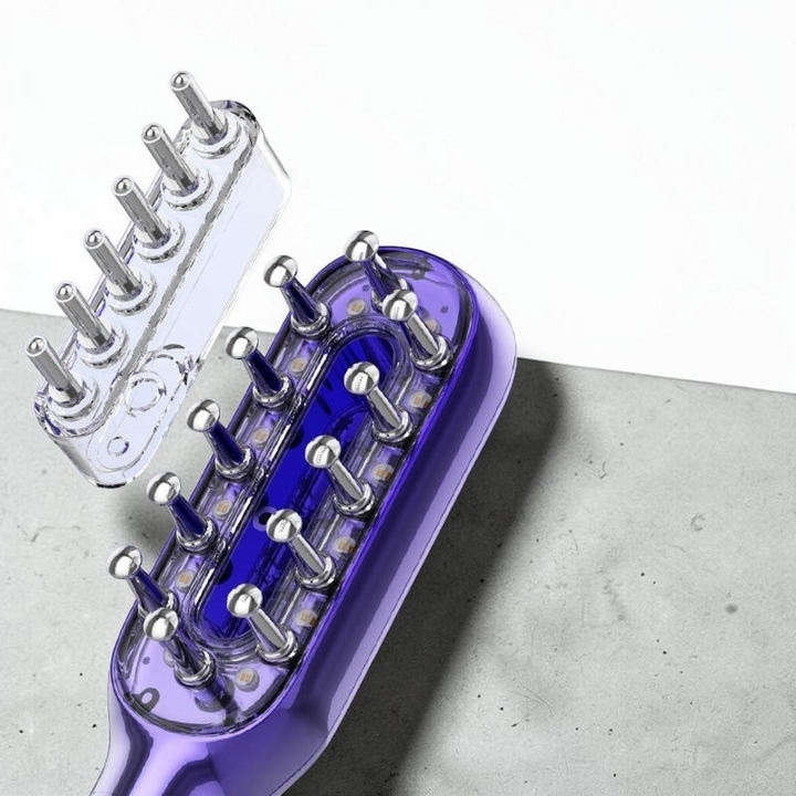 TheGromify vibrating red light hair growth comb with serum dropper attachment for scalp stimulation and hair regrowth.